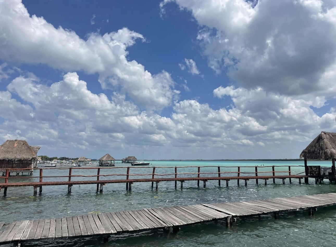 Overwater dock extending into a calm turquoise lagoon
